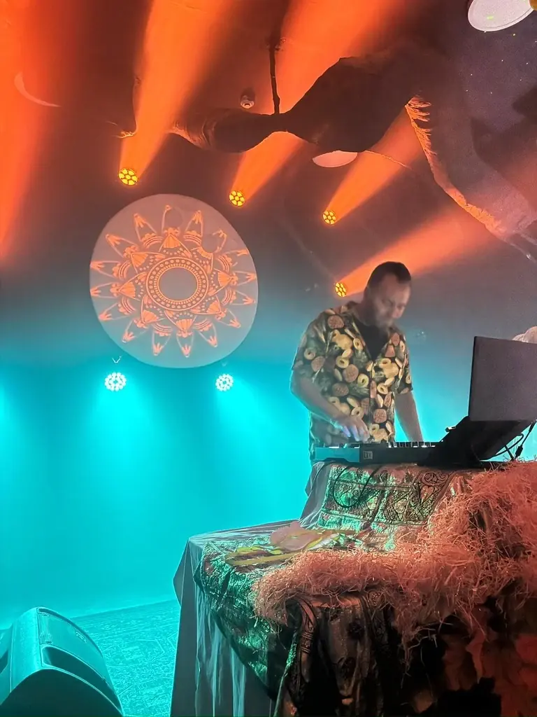 DJ Nimi — Performing under colorful stage lighting
